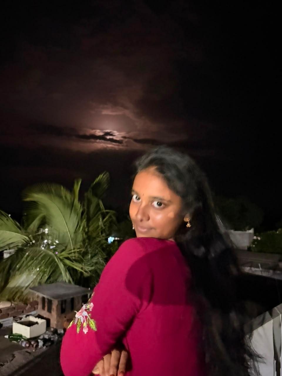 Jayani Bai on a rooftop under the moonlight