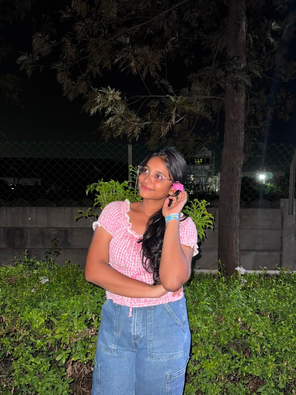 Jayani Bai with a flower in her hair, garden at night